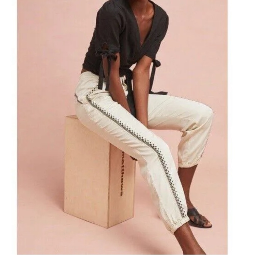 Anthropologie cream cargo pants with black embroidered detailing